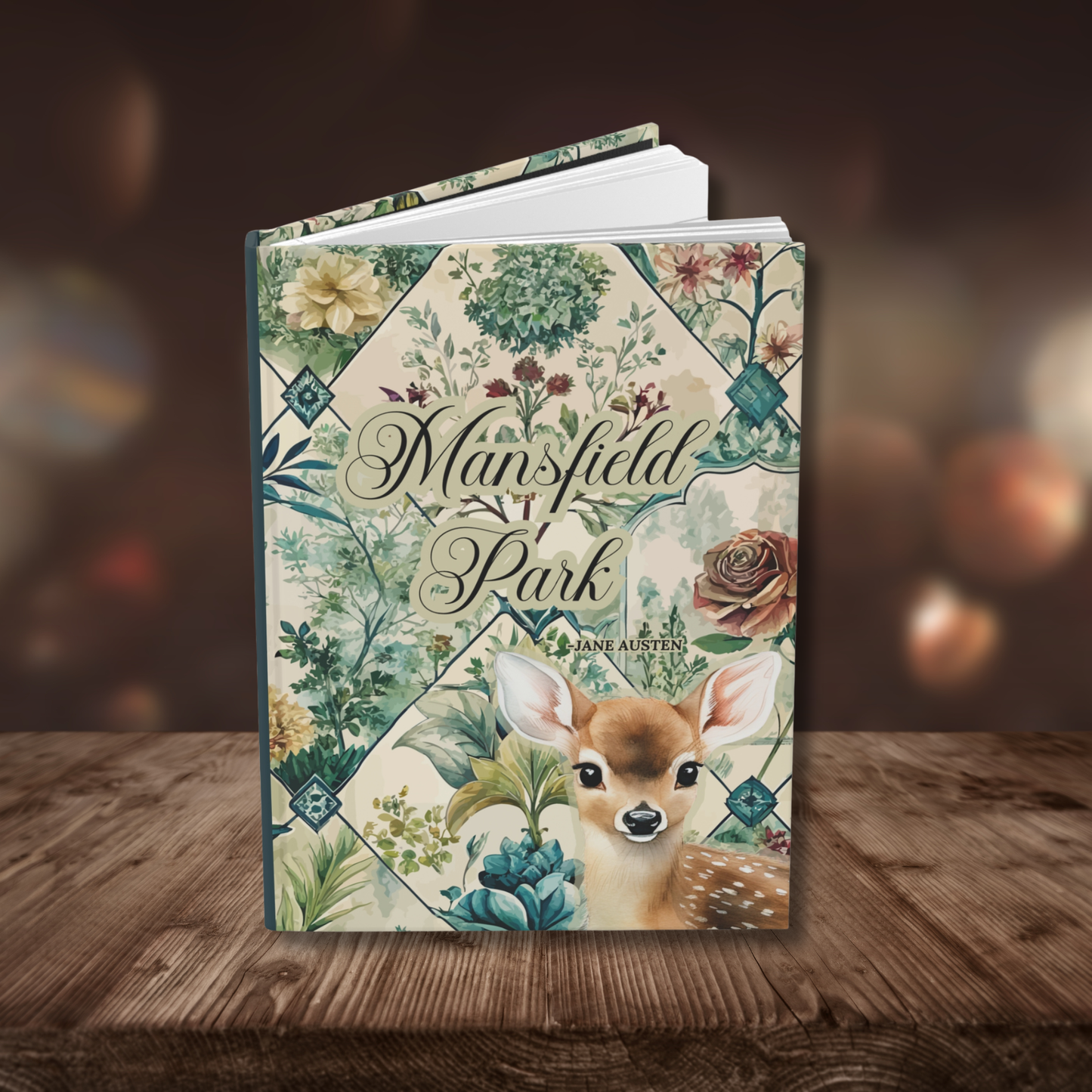 Notebook cover with 'Mansfield Park' written on the front. Floral toile design and deer illustration on a wooden surface.