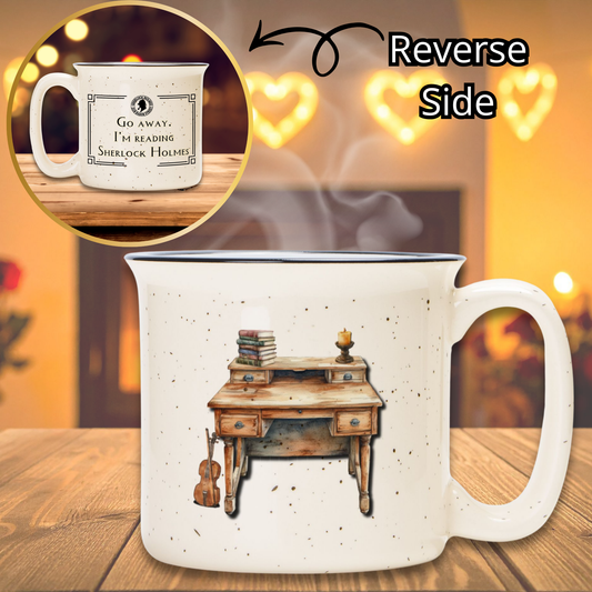 Mug with a desk illustration on one side and text on the other, placed on a wooden surface with a warm background.