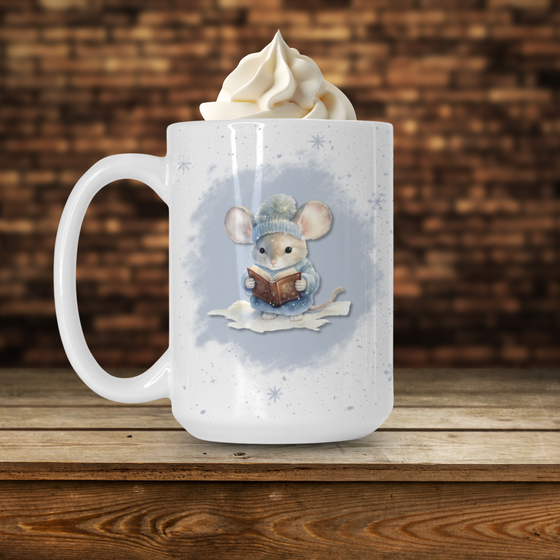 White mug with a mouse design holding a book, topped with whipped cream, on a wooden surface.