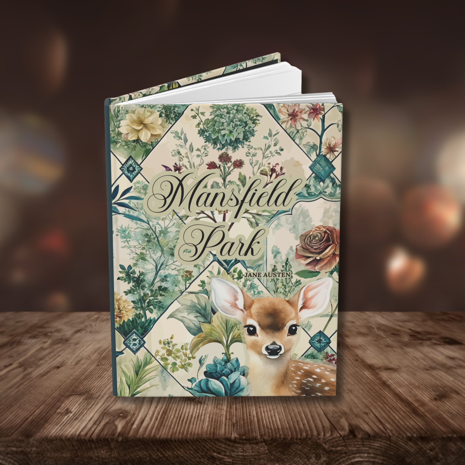 Notebook cover with 'Mansfield Park' written on the front. Floral toile design and deer illustration on a wooden surface.