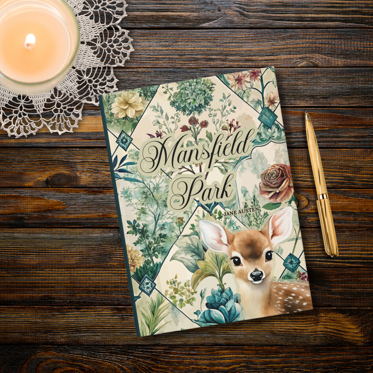 Notebook titled 'Mansfield Park' with a deer illustration on a wooden surface with a candle and pen.