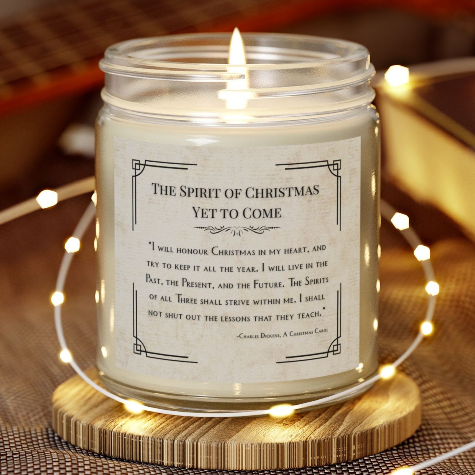Candle with a Christmas-themed label on a wooden coaster with string lights.