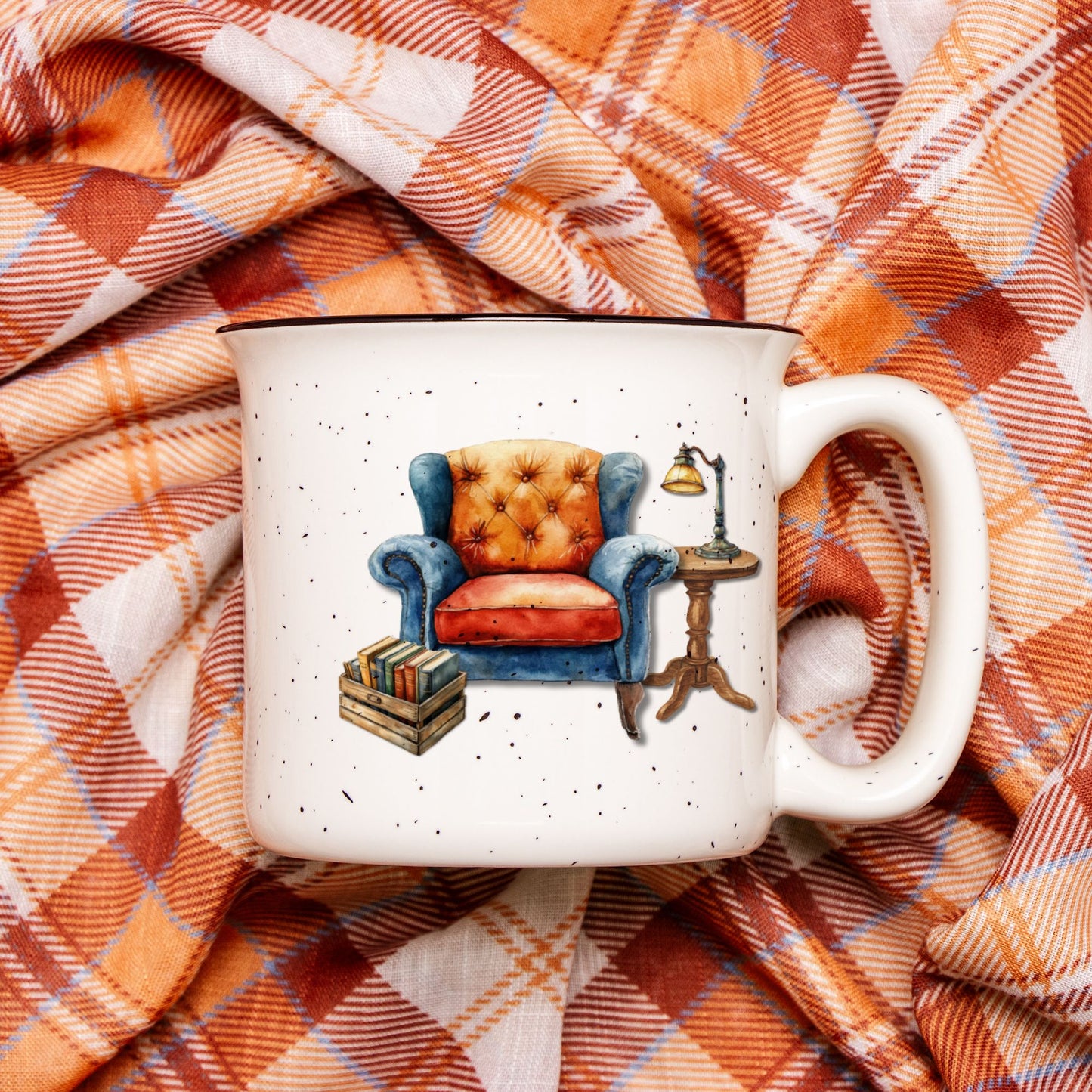 White mug with armchair design on a plaid fabric background