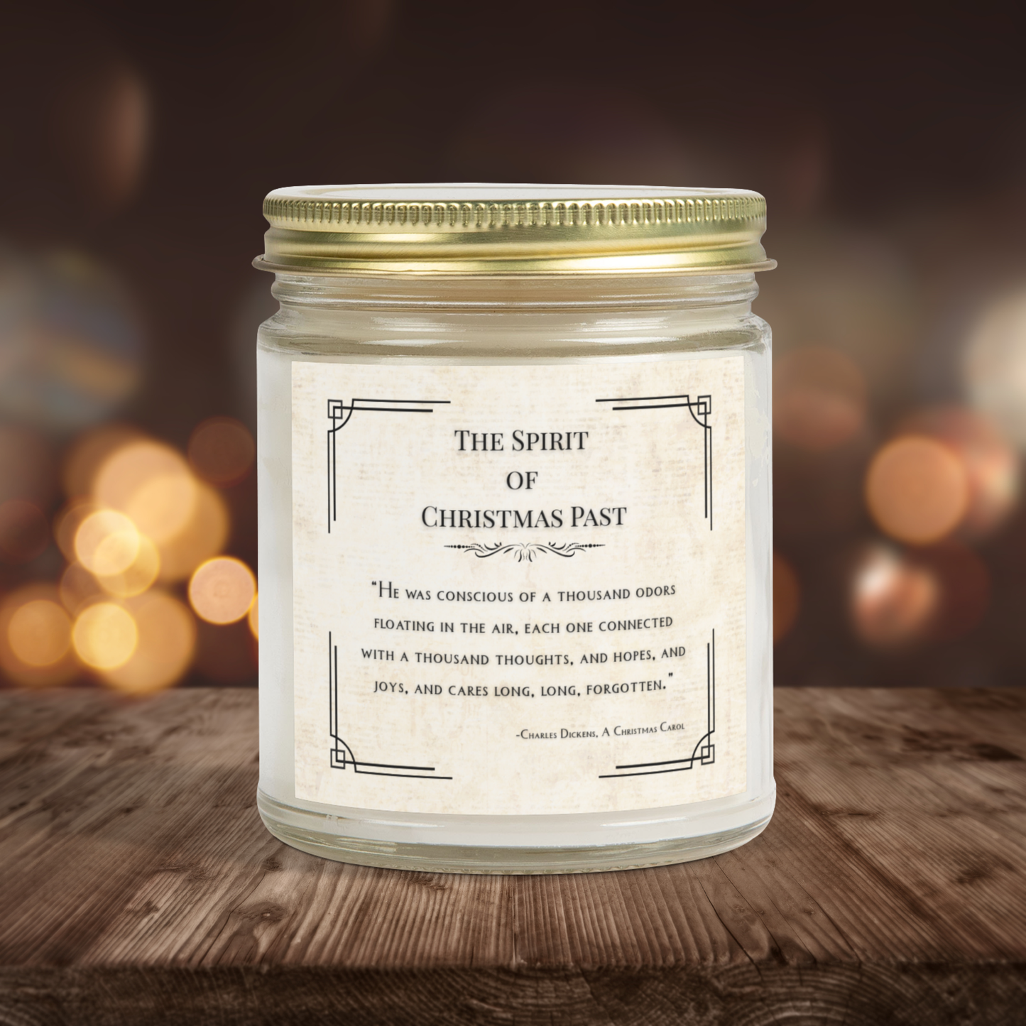 Candle jar with a label titled 'The Spirit of Christmas Past' on a wooden surface with a blurred background.