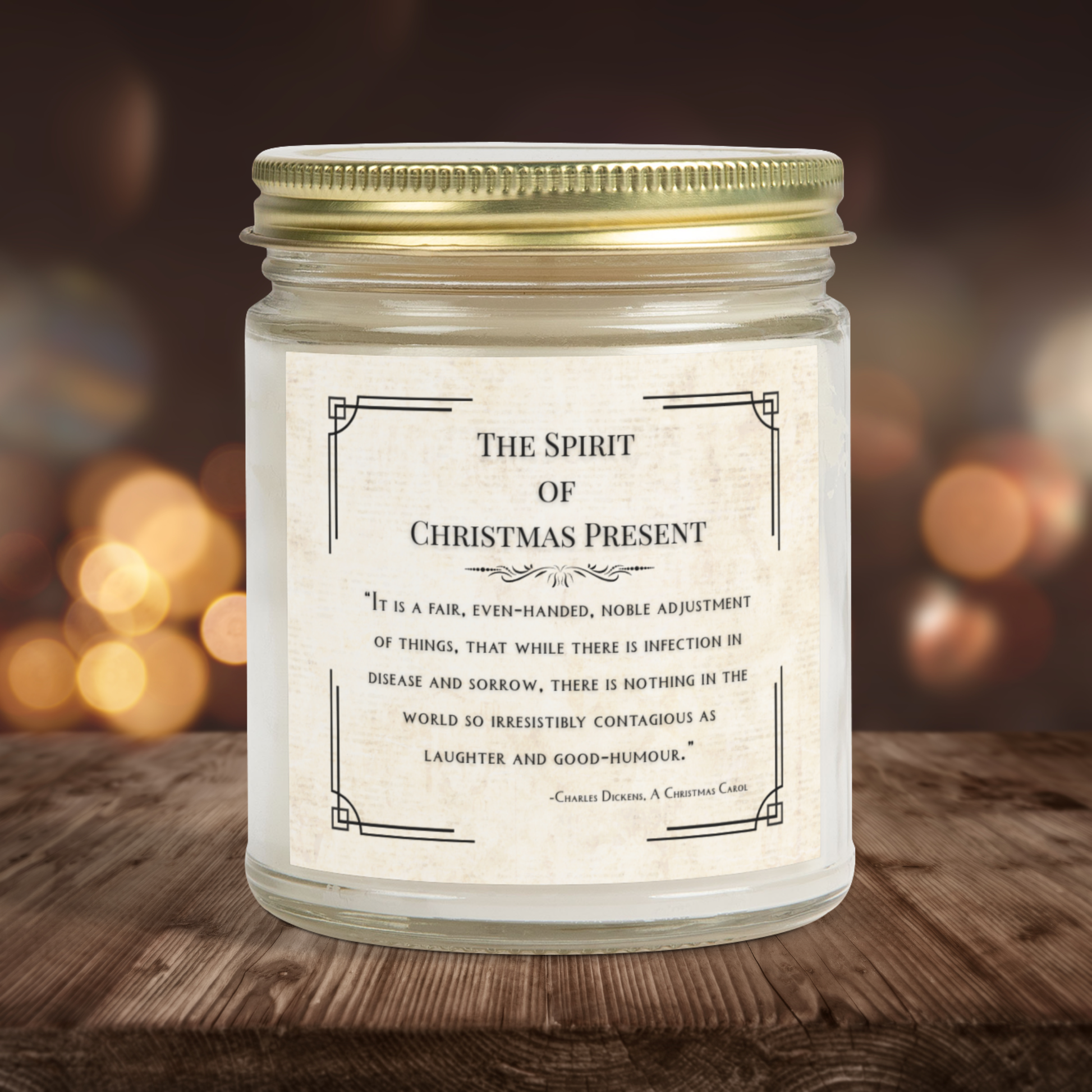 Candle jar with a Christmas-themed quote on a wooden surface with blurred lights in the background
