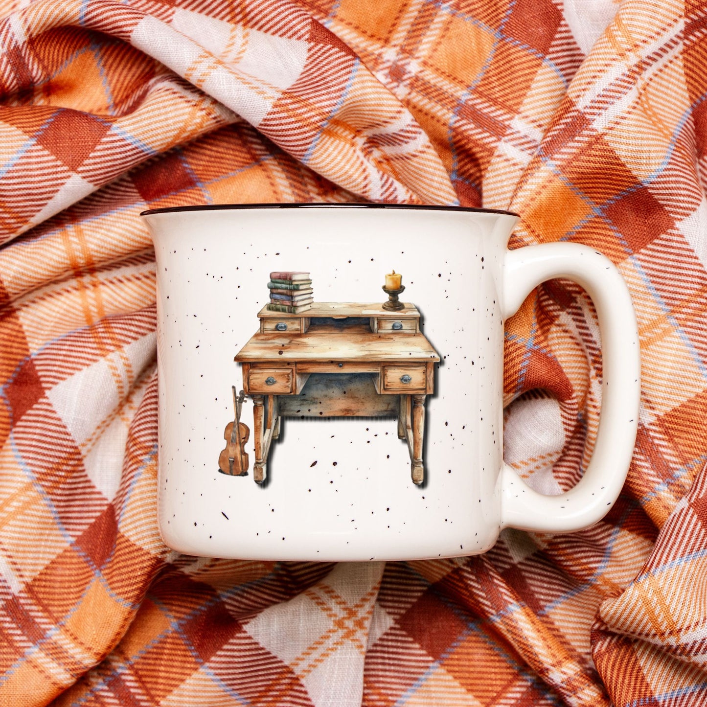 White mug with a wooden desk illustration on a plaid fabric background
