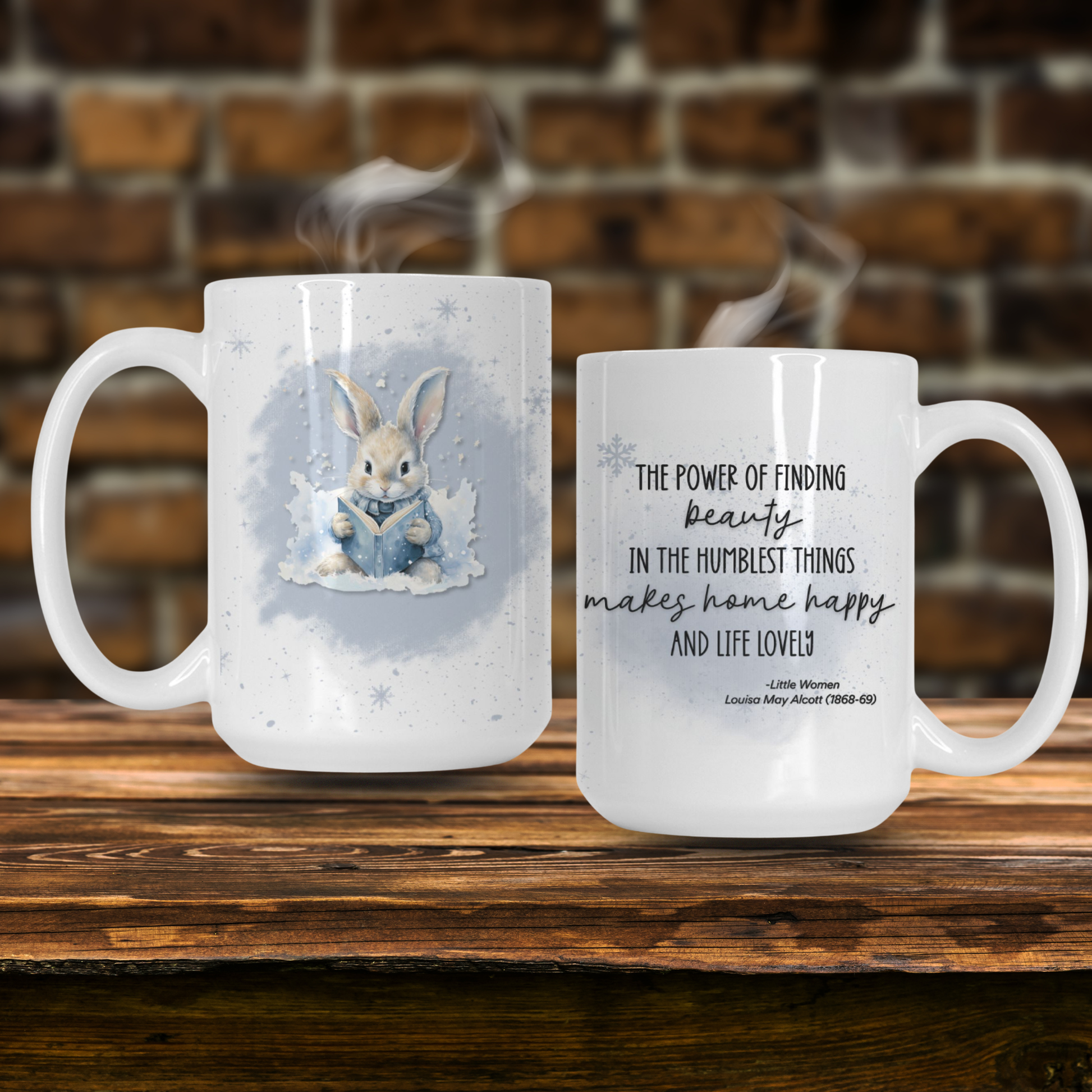 Two mugs on a wooden surface with one featuring a rabbit illustration and the other with a quote.