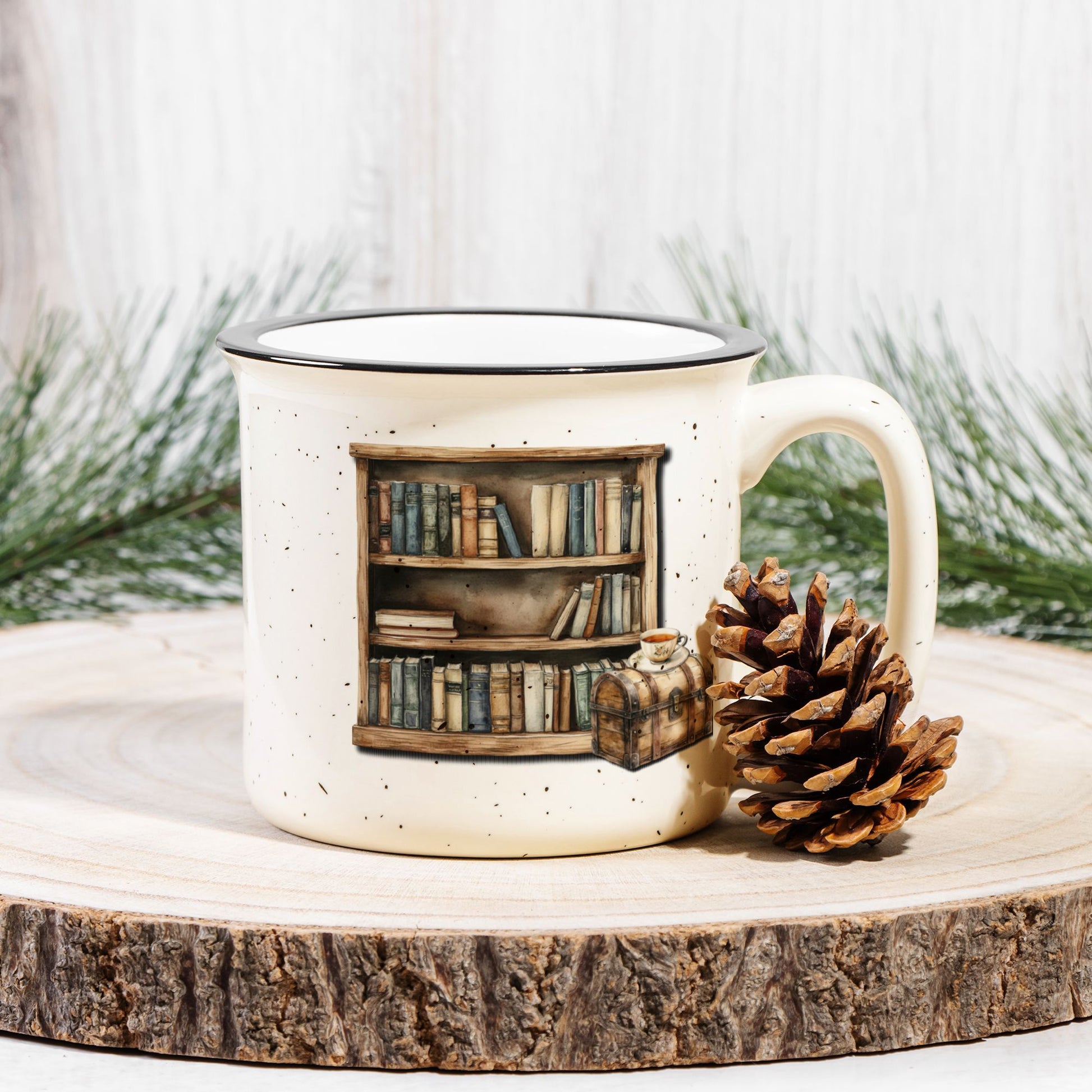 Mug with bookshelf design and pine cone on a wooden surface with a white background